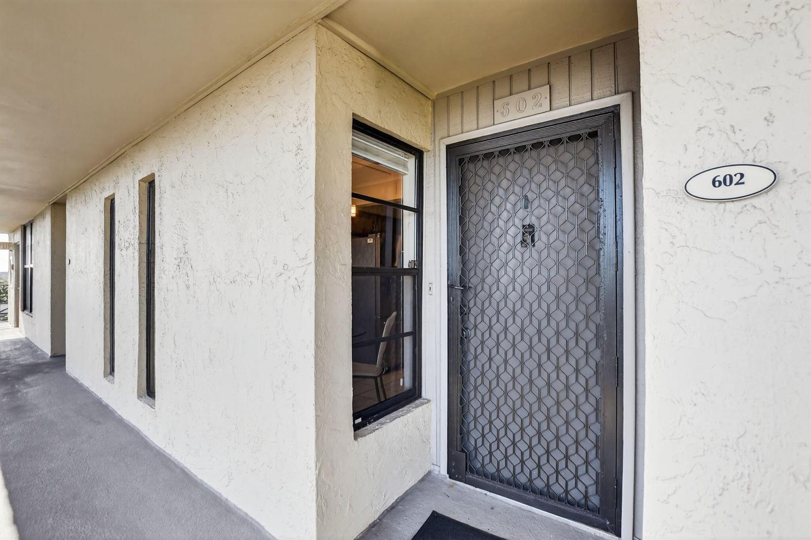 The exterior view shows a building entrance with a security door and unit number 602 — 20 Royal Palm Way # 602, Boca Raton FL 33432, BOCA RATON, FL