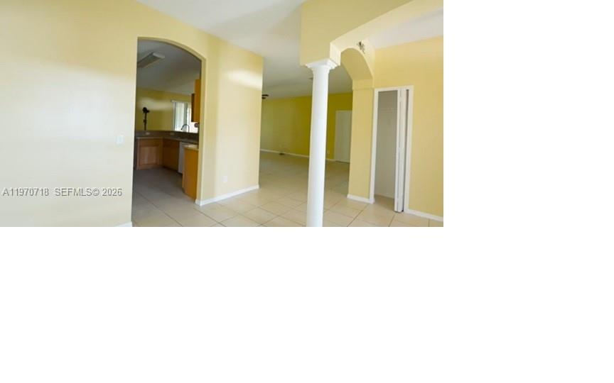 An interior view shows a kitchen entrance, a white column, and a closet door — 8720 97th Ave, Vero Beach FL 32967, VERO BEACH, FL