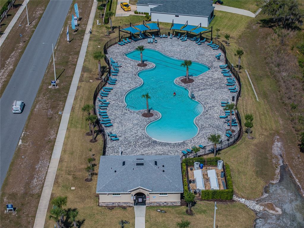 A single-story suburban house with a beige exterior, a two-car garage, and a concrete driveway — 3307 COSTELLO CIRCLE, WINTER HAVEN, FL