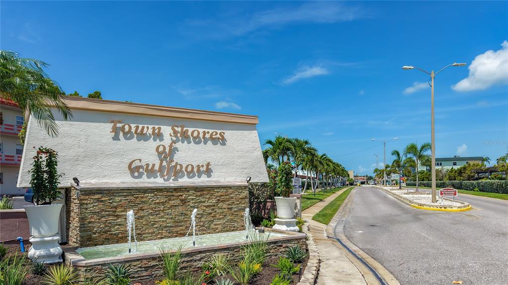 A stone fountain sits in front of a sign for Town Shores of Gulfport — 5935 30TH AVENUE S UNIT 104, GULFPORT, FL