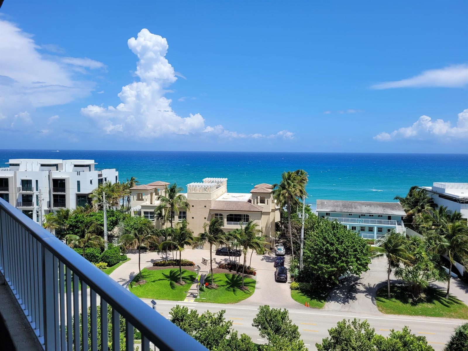 An elevated view of a coastal property featuring palm trees, buildings, and the ocean — 3700 S Ocean Boulevard # 705, Highland Beach FL 33487, HIGHLAND BEACH, FL