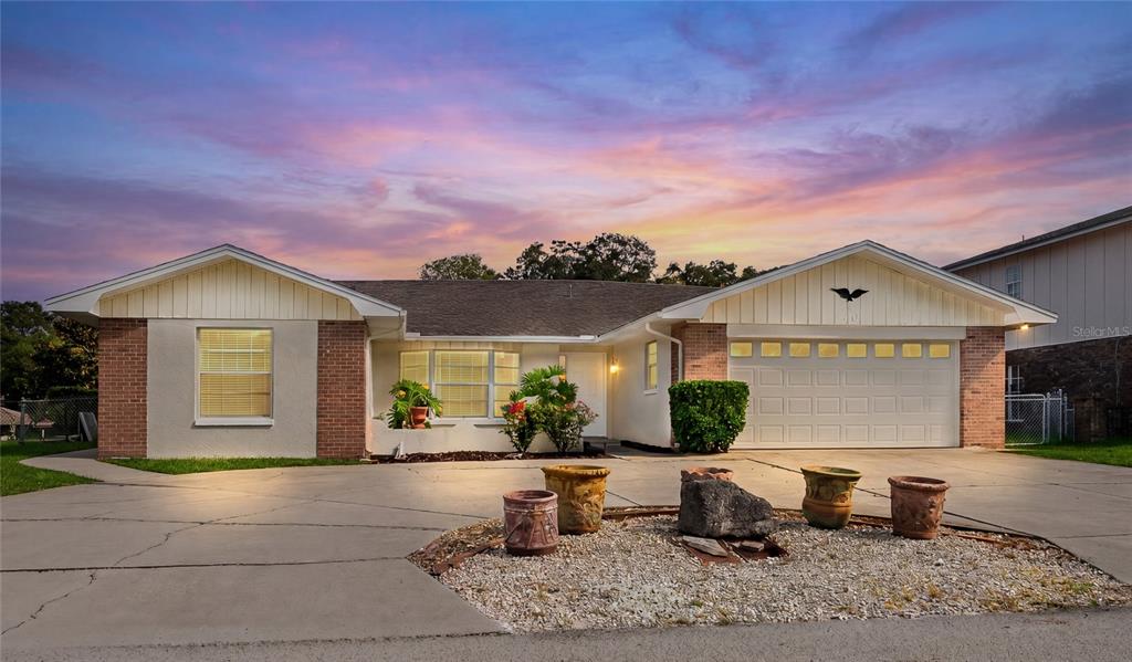 A single-story house with a brick and stucco exterior, a two-car garage, and a driveway — 10 FELICIA COURT, PALM COAST, FL