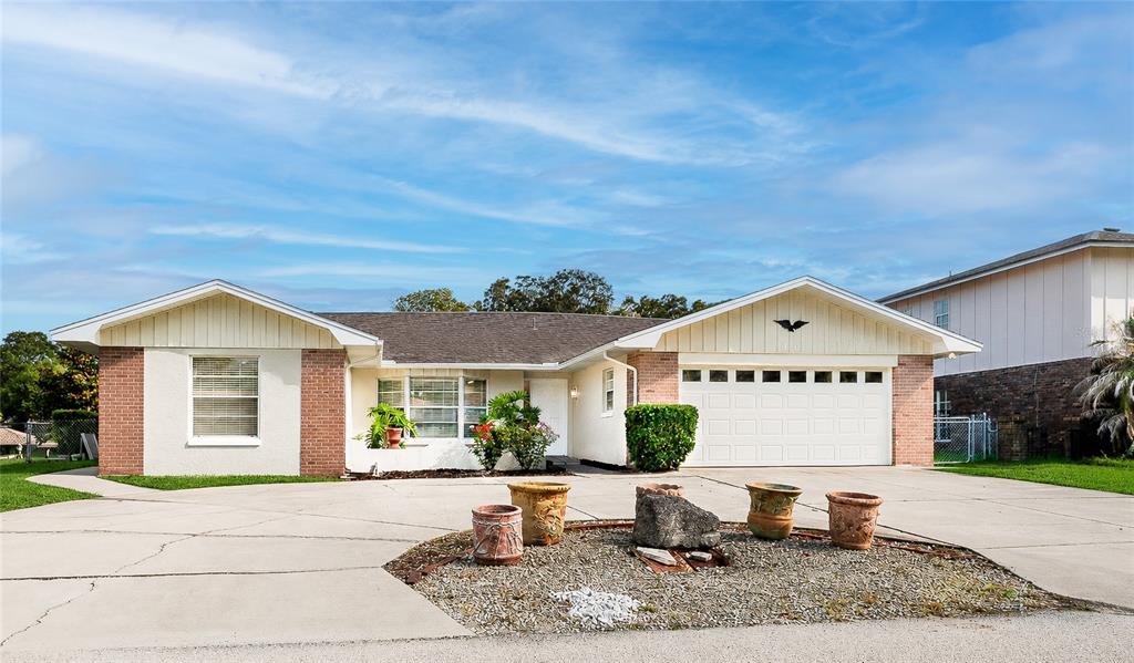 A single-story house with a brick and stucco exterior, a two-car garage, and a driveway — 10 FELICIA COURT, PALM COAST, FL