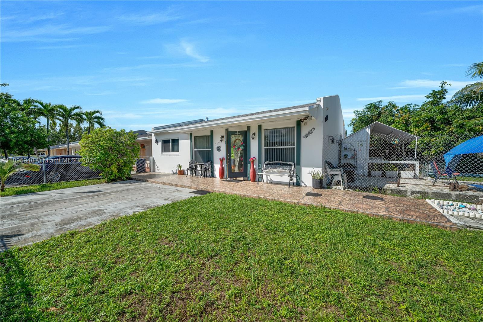 A single-story white house with a tiled front porch and a chain-link fenced yard — 5402 SW 128th Pl, Miami FL 33175, MIAMI, FL