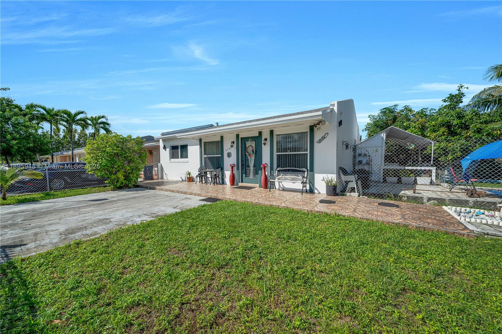 A single-story white house with a tiled front porch and a chain-link fenced yard — 5402 SW 128th Pl, Miami FL 33175, MIAMI, FL