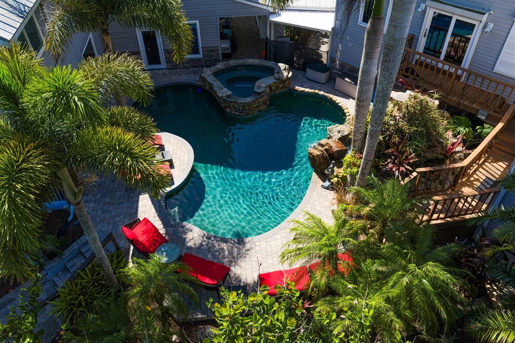 An aerial view of a backyard swimming pool with a spa and surrounding patio furniture — 1030 MILL CREEK ROAD, BRADENTON, FL