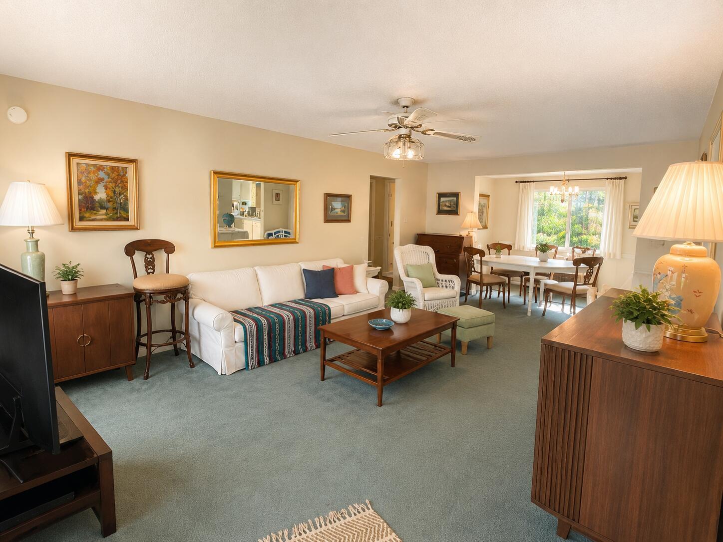 A living room with a white sofa, wooden coffee table, and dining area in the background — 2300 SW 19TH Avenue, Boynton Beach FL 33426, BOYNTON BEACH, FL