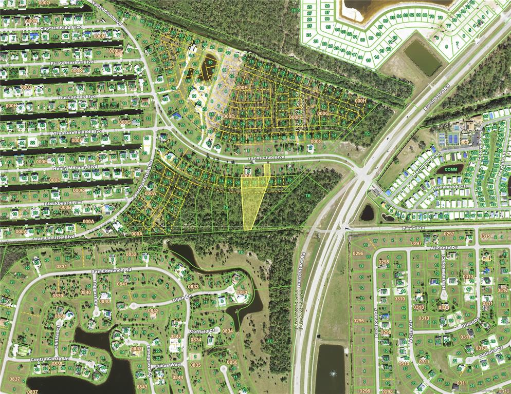 This is a map showing residential lots, streets, and undeveloped land in a suburban area — 24571 YACHT CLUB BOULEVARD, PUNTA GORDA, FL
