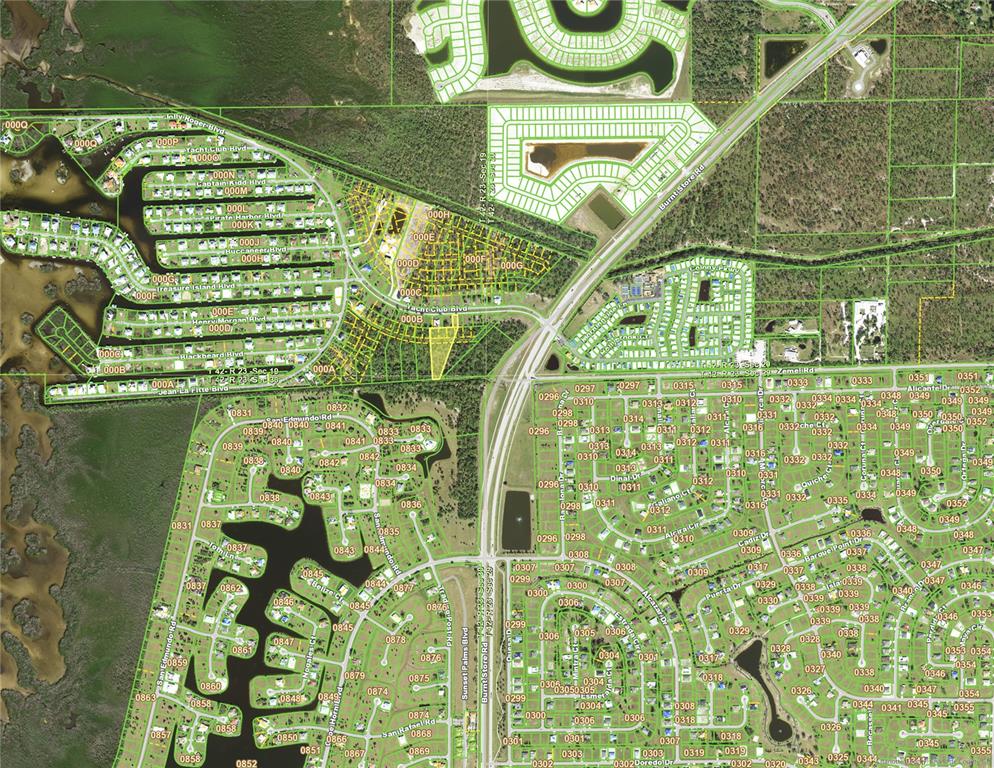 This is an aerial map showing residential neighborhoods, canals, and roads in a coastal area — 24571 YACHT CLUB BOULEVARD, PUNTA GORDA, FL