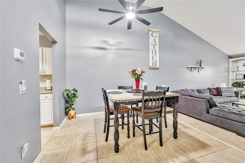 A dining area with a table and chairs sits beneath a vaulted ceiling and fan — 701 SAINT MICHAEL LANE, ALTAMONTE SPRINGS, FL