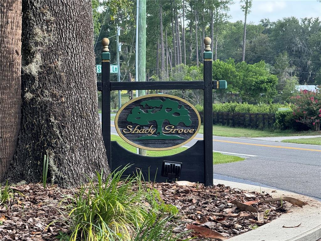 A black sign with the text Shady Grove stands next to a large tree — 2120 SW 76TH LANE, OCALA, FL