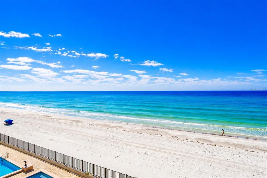 An elevated view of a white sand beach and turquoise ocean under a clear sky — 16750 GULF BOULEVARD UNIT 414, NORTH REDINGTON BEACH, FL