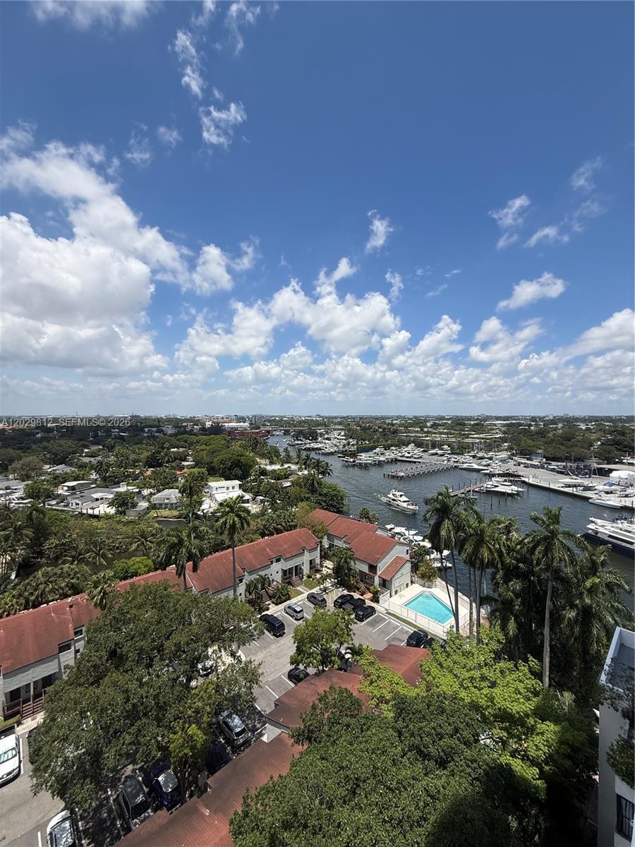 An elevated view shows a waterway with boats, surrounding trees, and residential buildings — 1861 NW S River Dr # 1403, Miami FL 33125, MIAMI, FL