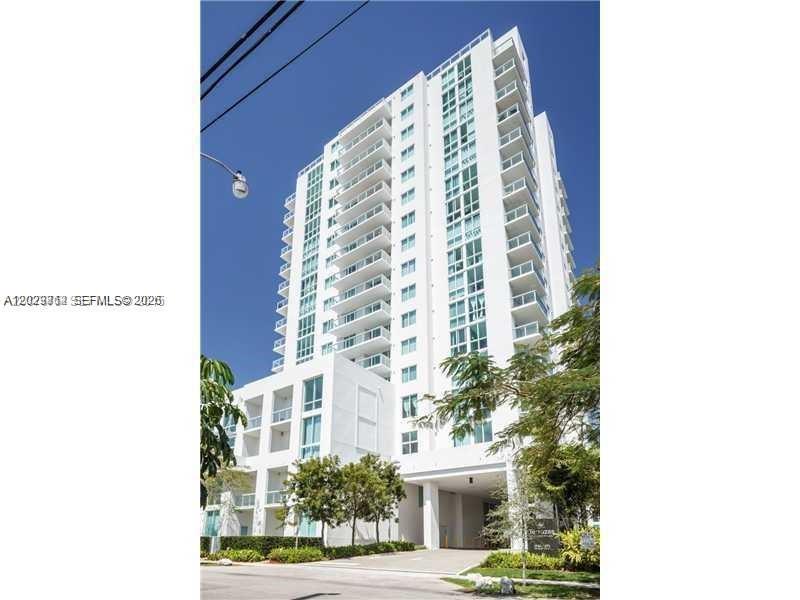 A tall white residential high-rise building features multiple balconies and a ground-level entrance — 1861 NW S River Dr # 1403, Miami FL 33125, MIAMI, FL