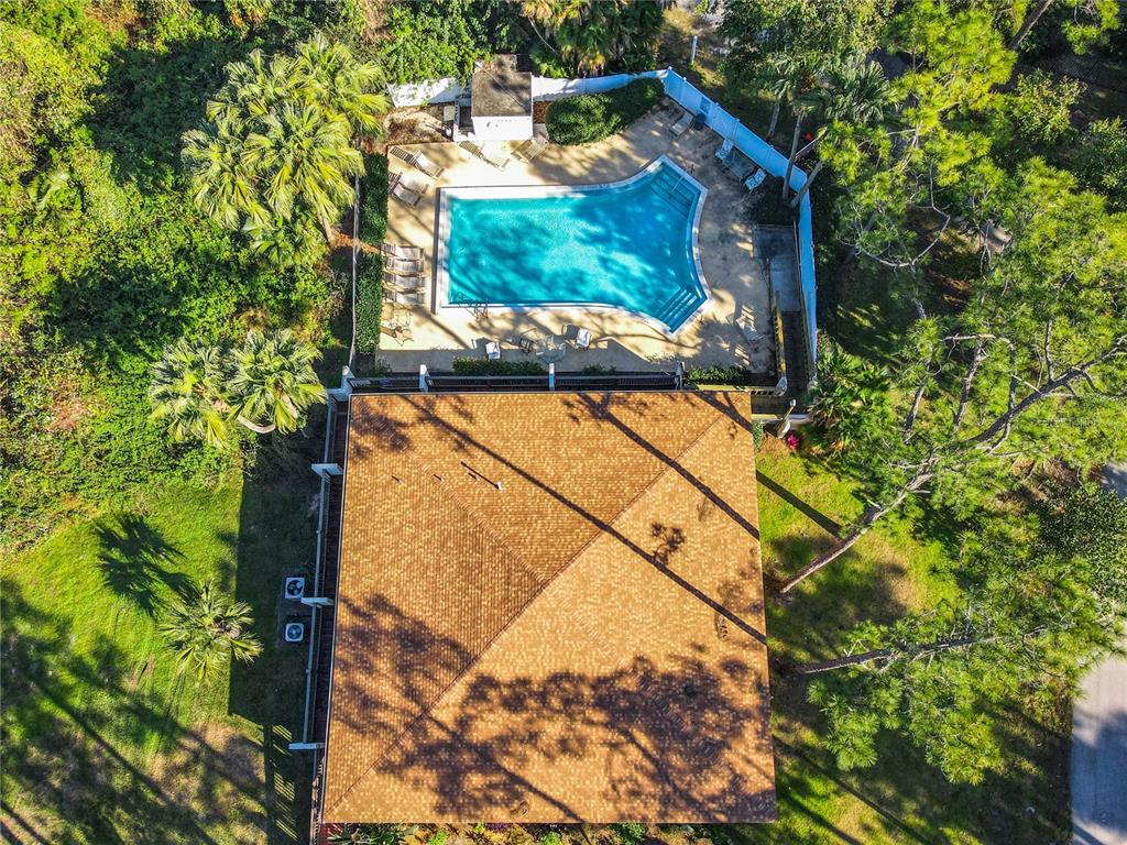 An aerial view shows a house with a shingled roof next to a swimming pool — 381 SAN JOSE DRIVE, WINTER HAVEN, FL