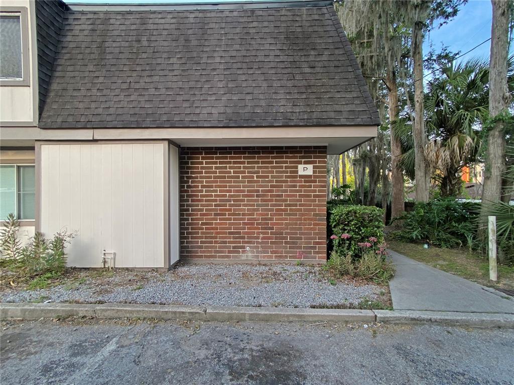 A brick and siding exterior of a building with a shingled roof and gravel landscaping — 1700 SW 16TH COURT UNIT P6, GAINESVILLE, FL
