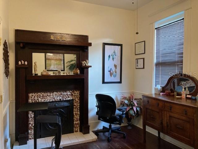 A room with a dark wood fireplace, a desk chair, and a wooden dresser — 806 W DE LEON STREET, TAMPA, FL