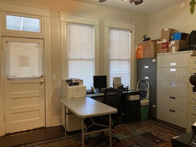 An office room features a desk, printer, filing cabinets, and a door with a window — 806 W DE LEON STREET, TAMPA, FL