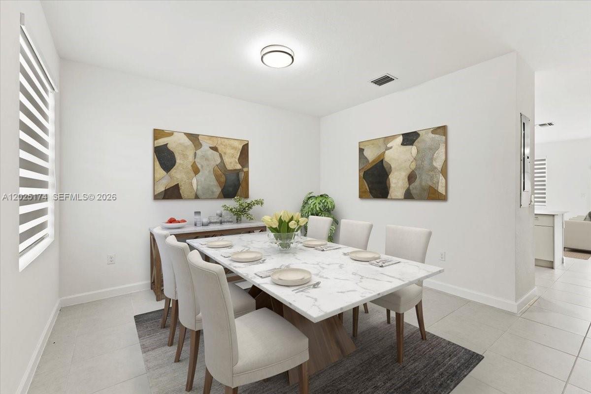 A dining room features a marble-topped table, six upholstered chairs, and two abstract wall paintings — 35779 SW 178th Ct, Miami FL 33034, MIAMI, FL