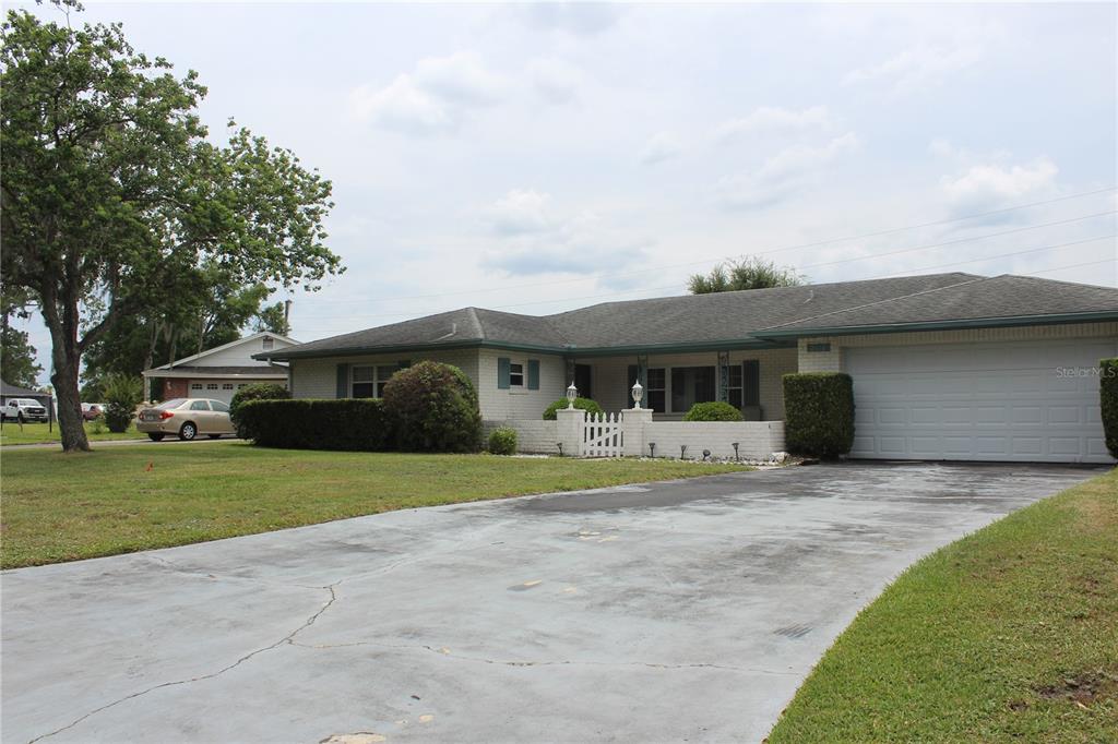 A single-story brick house with a two-car garage and a paved driveway — 2324 HALEY COURT, KISSIMMEE, FL