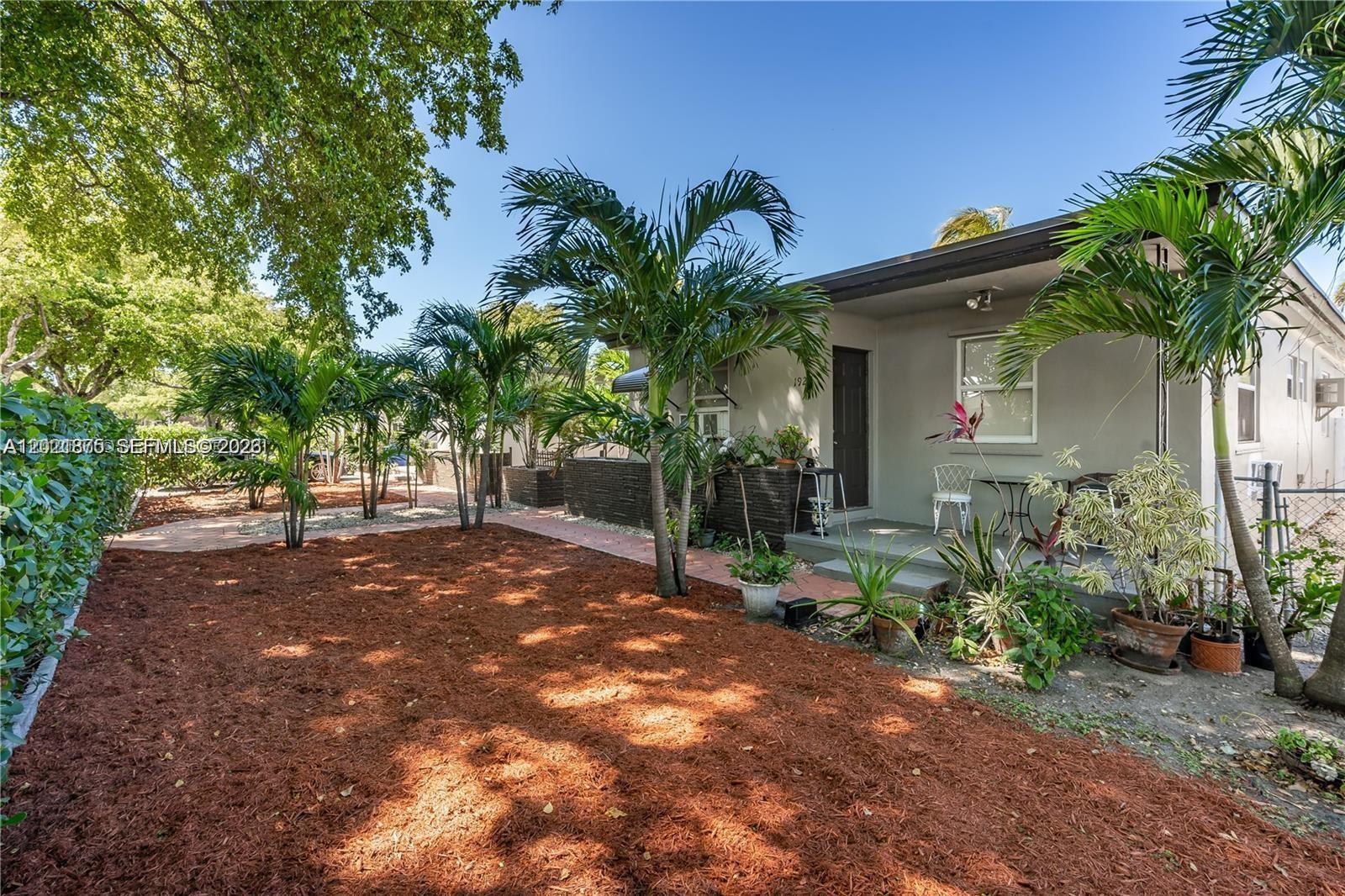 A single-story house exterior features a covered porch, palm trees, and a mulch-covered yard — 1925 Dewey St # 1925, Hollywood FL 33020, HOLLYWOOD, FL