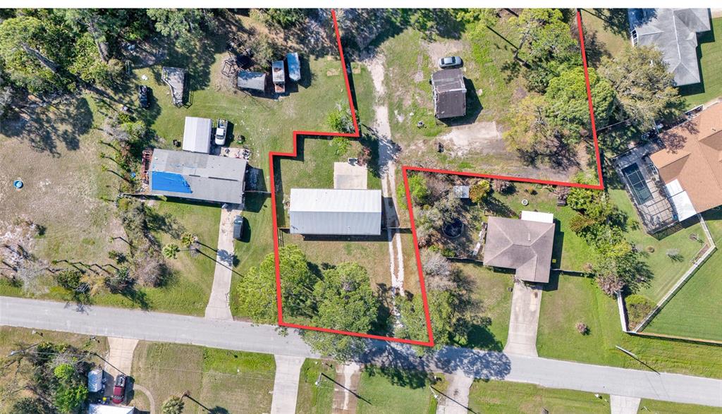 An aerial view shows a residential property with a metal-roofed building outlined in red — 200 28TH STREET, EDGEWATER, FL