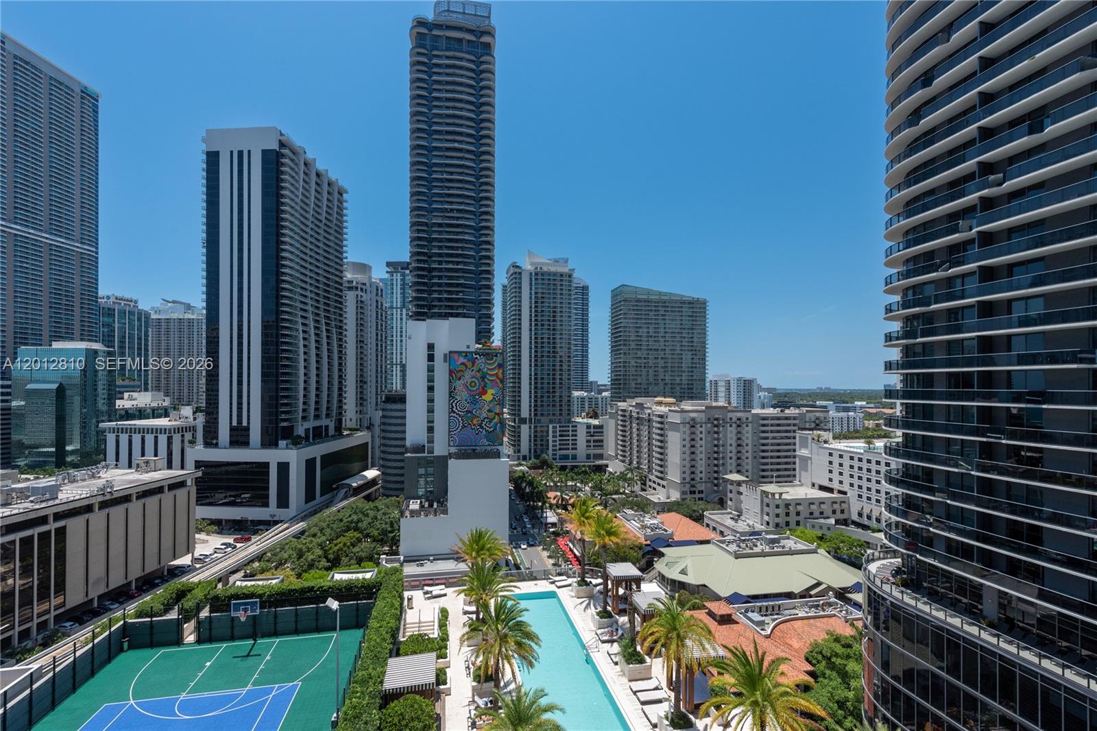 An elevated view of a city skyline featuring a tennis court and swimming pool — 801 S Miami Ave # 1602, Miami FL 33130, MIAMI, FL