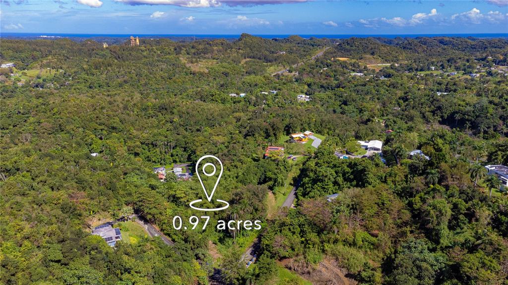 An aerial view shows a wooded landscape with a marked 0.97-acre plot of land — URB. HACIENDAS DEL DORADO CALLE GUAYACAN A30, TOA ALTA, PR