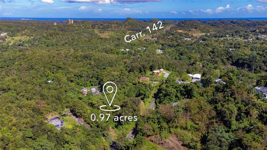 An aerial view shows a wooded landscape with scattered houses and a labeled 0.97-acre plot — URB. HACIENDAS DEL DORADO CALLE GUAYACAN A30, TOA ALTA, PR