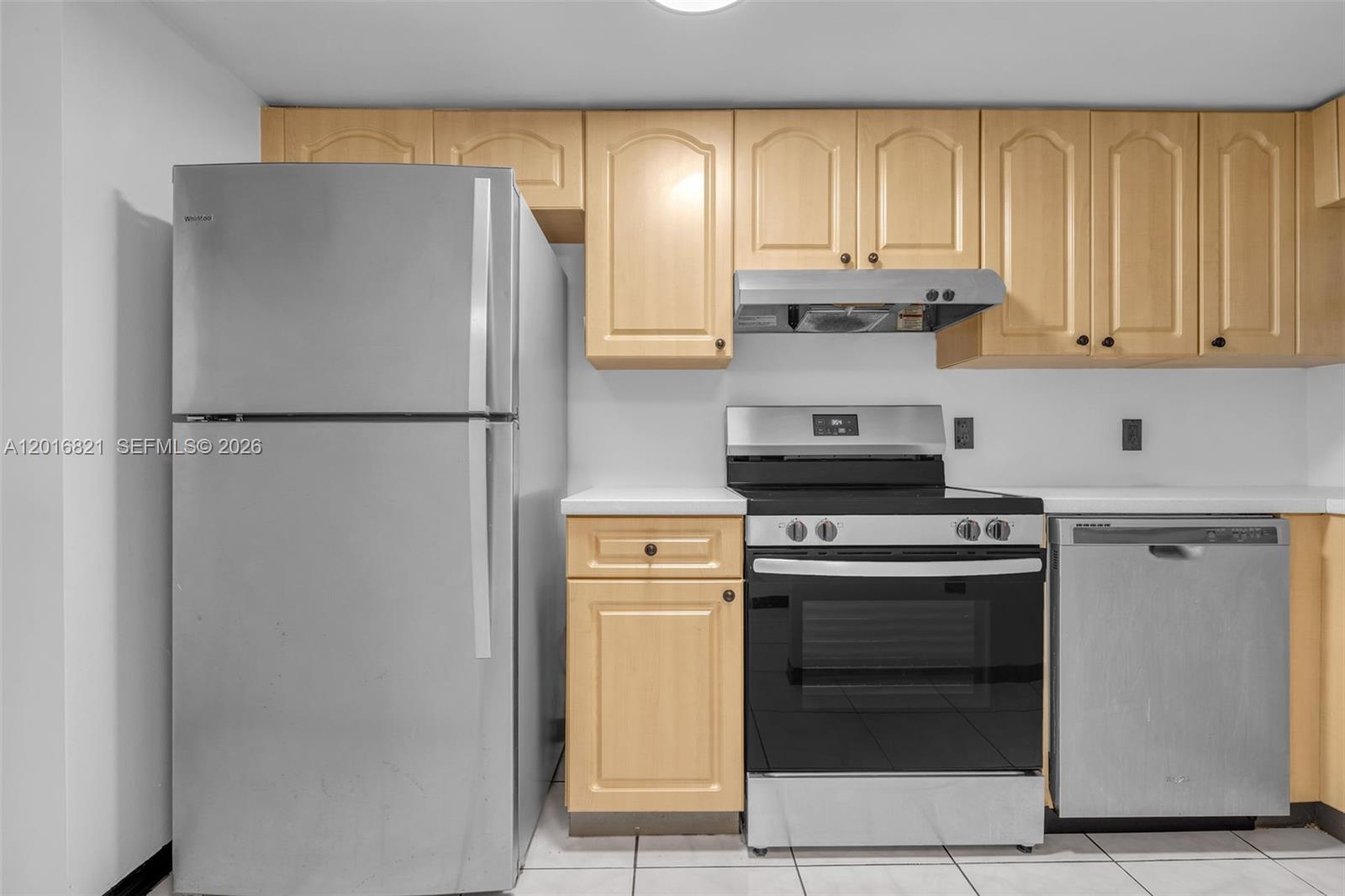 A kitchen features light wood cabinets, stainless steel appliances, and white countertops — 102 SW 6th Ave # 201, Miami FL 33130, MIAMI, FL