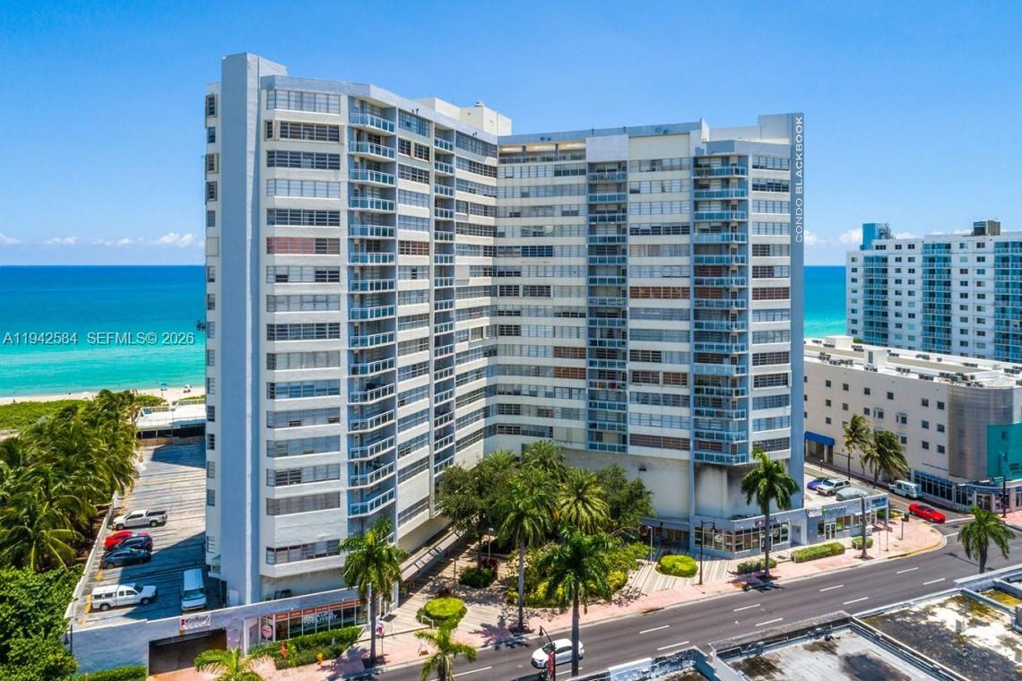 An aerial view of a tall, multi-story residential building located directly next to the ocean — 7135 Collins Ave # 1011, Miami Beach FL 33141, MIAMI BEACH, FL