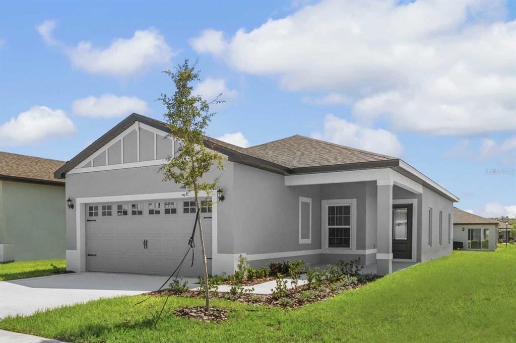 A single-story gray house with a two-car garage and a covered front entryway — 3621 AMANATSU AVENUE, LAKE ALFRED, FL