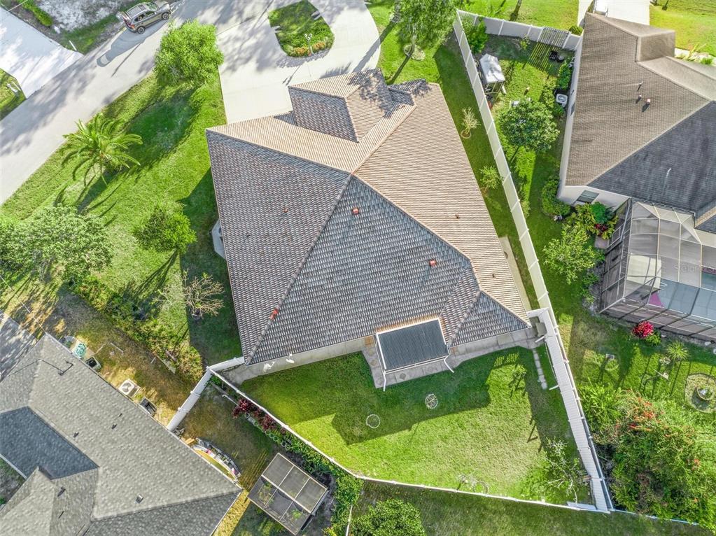 An aerial view shows a house with a tiled roof and a fenced backyard — 3 FALLS PLACE, PALM COAST, FL