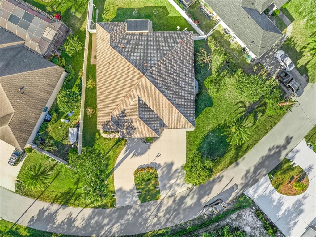 An aerial view shows a residential house with a tiled roof and a concrete driveway — 3 FALLS PLACE, PALM COAST, FL