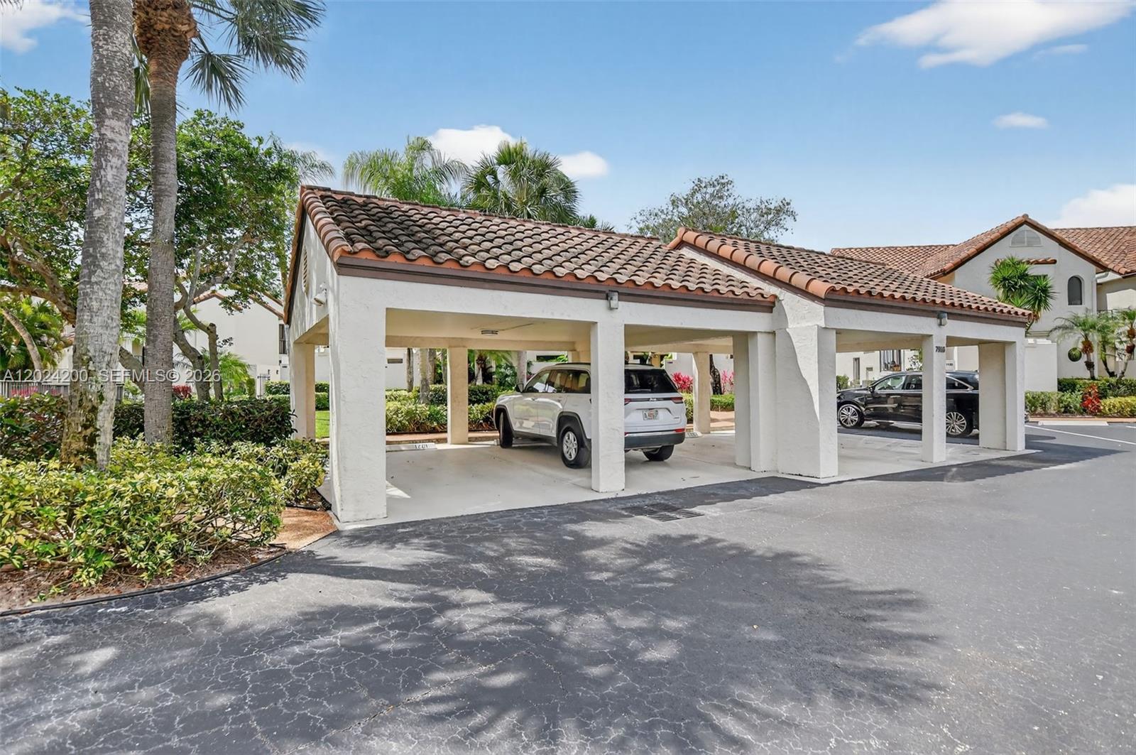 A covered parking structure with a tiled roof sits in a paved residential lot — 7906 Granada Pl # 1201, Boca Raton FL 33433, BOCA RATON, FL