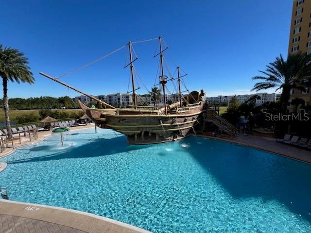 A large pirate ship structure sits in the middle of a swimming pool — 8000 POINCIANA BOULEVARD UNIT 2705, ORLANDO, FL