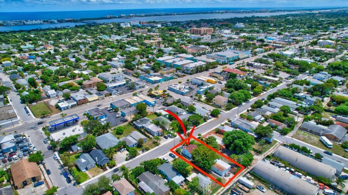 An aerial view shows a residential property highlighted in red within a suburban neighborhood — 415 N H Street, FL 33460, FL