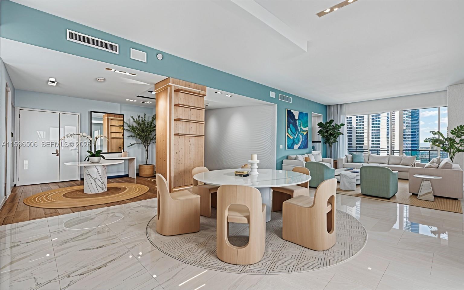 A modern open-concept living and dining area features light wood furniture, marble floors, and city views — 900 Brickell Key Blvd # 1002, Miami FL 33131, MIAMI, FL