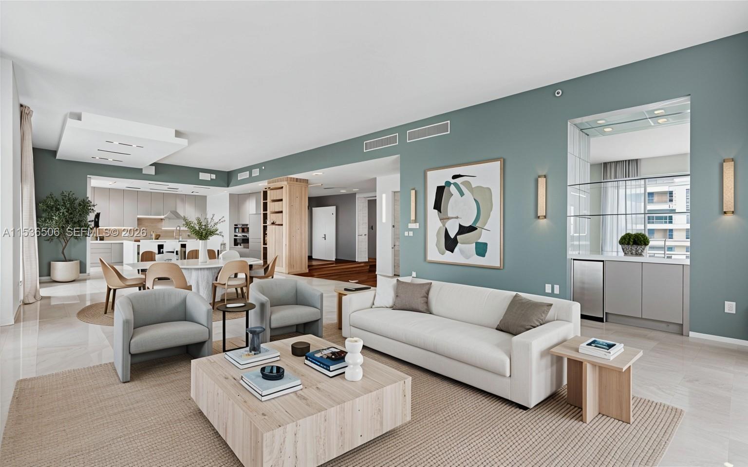 This open-concept living and dining area features light wood furniture, a white sofa, and blue-green walls — 900 Brickell Key Blvd # 1002, Miami FL 33131, MIAMI, FL