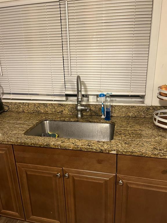 A kitchen sink with a stainless steel basin and faucet set in a granite countertop — 744 MYRTLE AVENUE, VENICE, FL