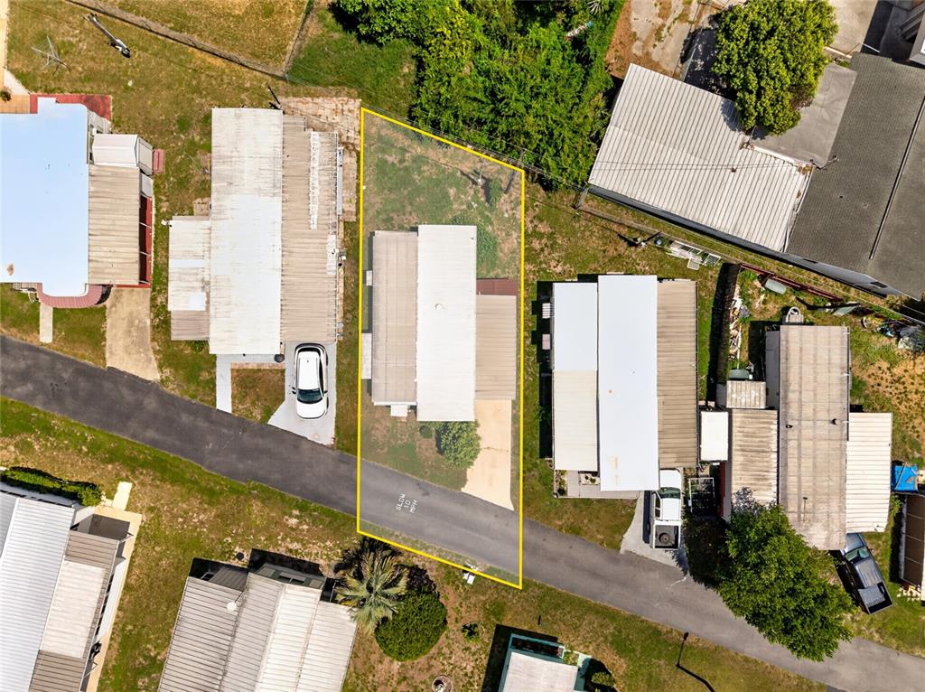 This aerial view shows a residential lot with a mobile home and driveway — 37433 RAY DRIVE, ZEPHYRHILLS, FL