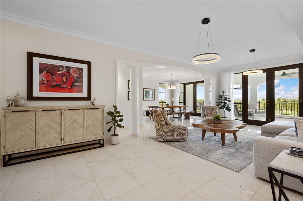 A bright living room features light tile floors, a wooden coffee table, and dining area — 406 COCO BEACH BVL UNIT 401A, RIO GRANDE, PR