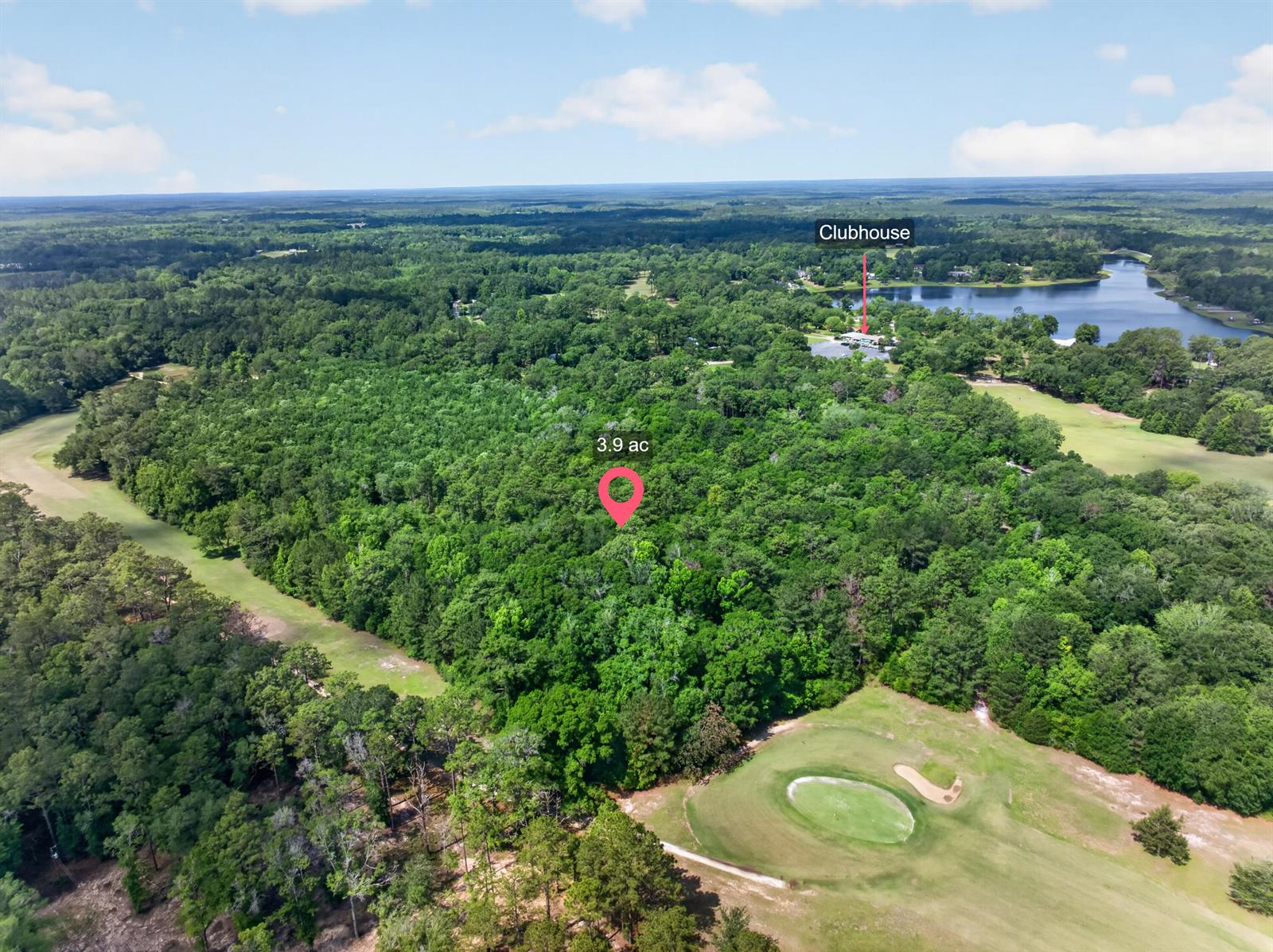 An aerial view shows a wooded 3.9-acre lot situated next to a golf course — 2744-2748 Little John Lane, FL 32425, FL
