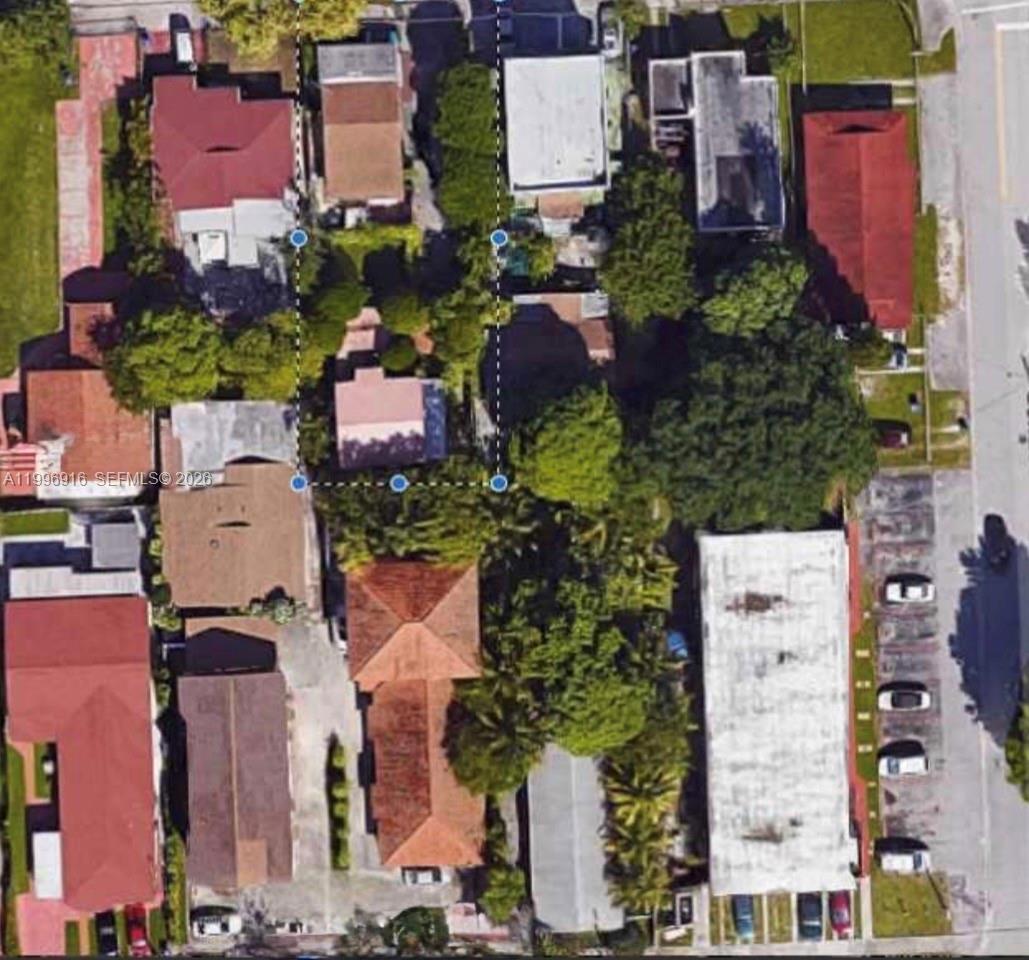 This aerial view shows several residential buildings and properties with surrounding trees and parking areas — 2528 SW 16th St, Miami FL 33145, MIAMI, FL