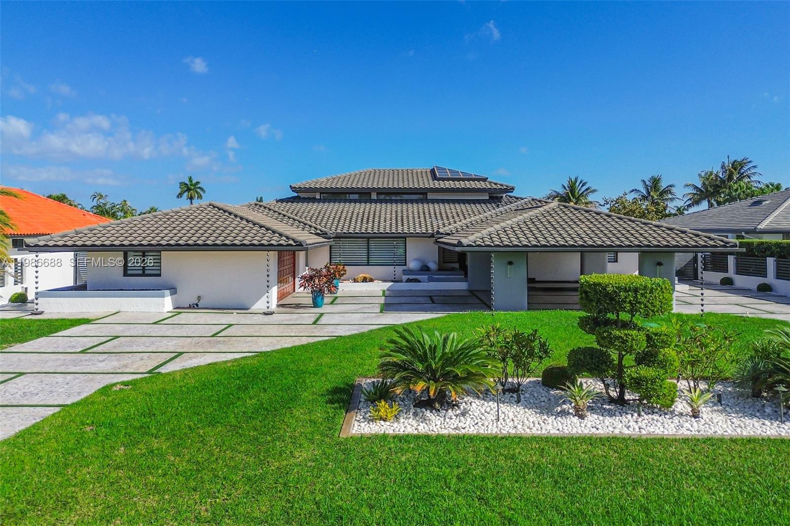 A single-story house with a tiled roof, concrete driveway, and landscaped front yard — 13801 SW 34th St, Miami FL 33175, MIAMI, FL