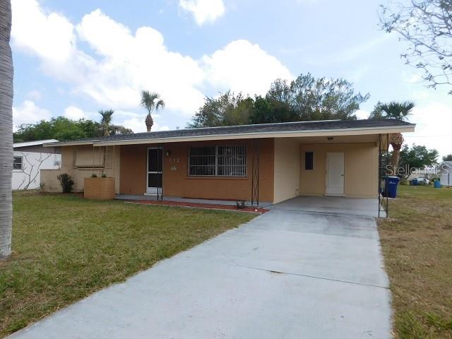 A single-story house with a brick facade, a front porch, and an attached carport — 612 SHAMROCK BOULEVARD, VENICE, FL