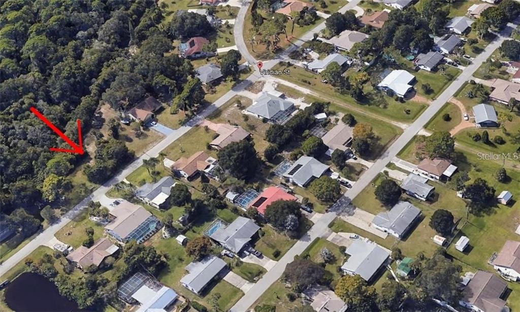 An aerial view shows a vacant, wooded residential lot marked by a red arrow — Lot 39 VIRIDIAN STREET, ENGLEWOOD, FL