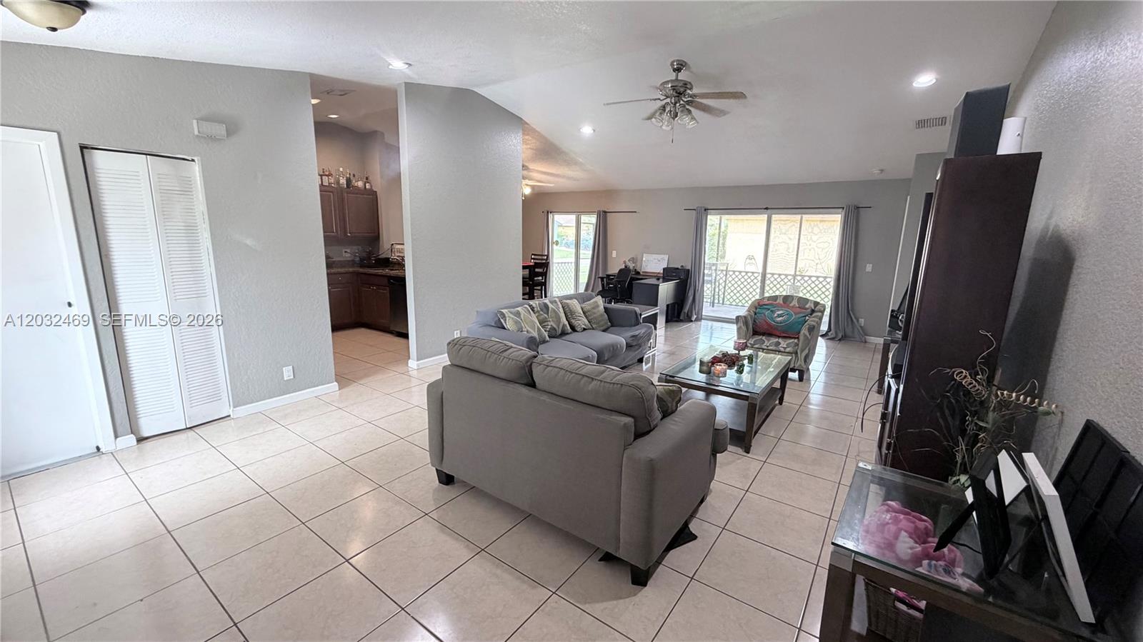 A living room with tile floors, a ceiling fan, and an adjacent kitchen area — 5356 NW 93rd Ter, Sunrise FL 33351, SUNRISE, FL