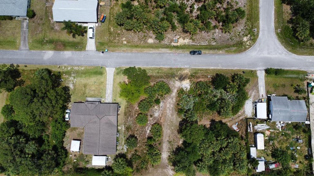 An aerial view shows a residential lot with a house, driveway, and surrounding vegetation — 480 TRUMAN STREET SW, PALM BAY, FL