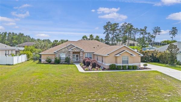 A single-story house with a stone facade and a tan exterior sits on a lawn — 4190 SW 103RD STREET ROAD, OCALA, FL